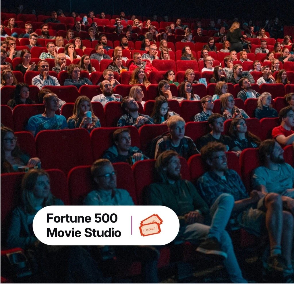 Moviegoers sit in a theater. Text overlaid says "Fortune 500 Movie Studio".