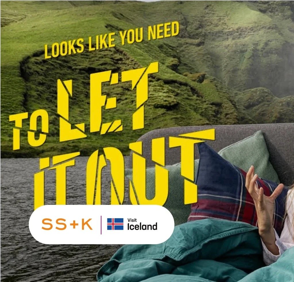 An image of a person laying in bed with Iceland in the background. Text overlaid reads "Looks like you need to let it out".